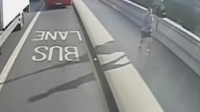 VIDEO: Un corredor empuja a una mujer a las ruedas de un autobús