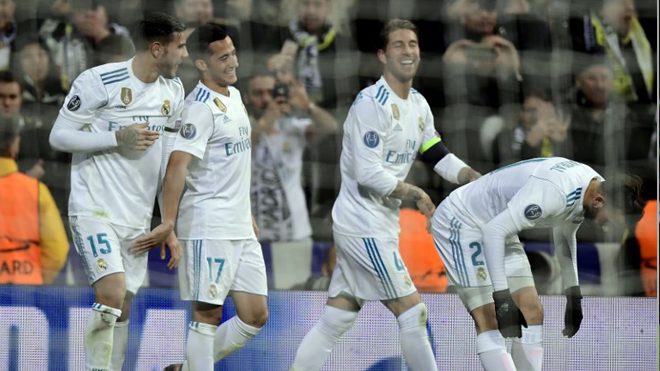 Champions Real Madrid's Spanish midfielder Lucas Vazquez (L) celebrates a goal with teammates during the UEFA Champions League group H football match Real Madrid CF vs Borussia Dortmund at the Santiago Bernabeu stadium in Madrid on December 6, 2017. JAVIER SORIANO / AFP