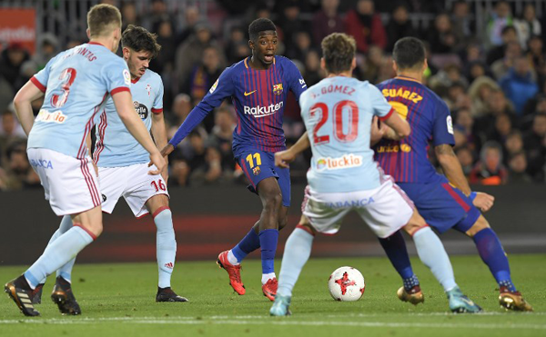 Barcelona's French forward Ousmane Dembele (C) vies with Celta Vigo's Spanish defender Sergi Gomez during the Spanish Copa del Rey (King's Cup) round of 16 second leg football match FC Barcelona vs RC Celta de Vigo at the Camp Nou stadium in Barcelona on January 11, 2018. LLUIS GENE / AFP