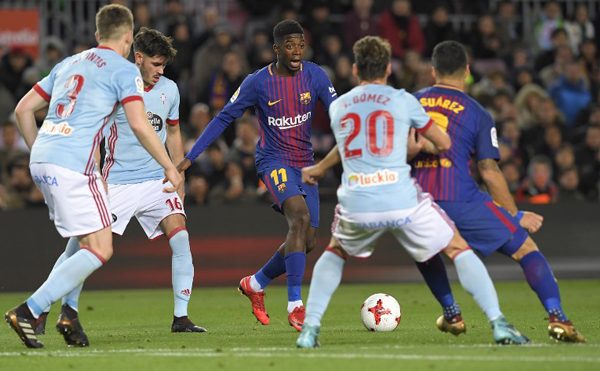 Barcelona's French forward Ousmane Dembele (C) vies with Celta Vigo's Spanish defender Sergi Gomez during the Spanish Copa del Rey (King's Cup) round of 16 second leg football match FC Barcelona vs RC Celta de Vigo at the Camp Nou stadium in Barcelona on January 11, 2018. LLUIS GENE / AFP