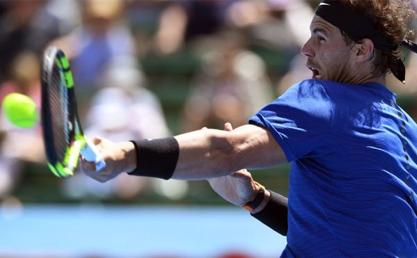 Rafael Nadal of Spain hits a forehand return to Richard Gasquet of France at Kooyong Classic tennis tournament in Melbourne on January 9, 2018. WILLIAM WEST / AFP