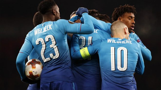 Arsenal's German-born Bosnian defender Sead Kolasinac (C) celebrates with teammates after scoring their first goal during the second leg of the Europa League Round of 32 football match between Arsenal and Ostersunds at the Emirates Stadium in London on February 22, 2018. Adrian DENNIS / AFP
