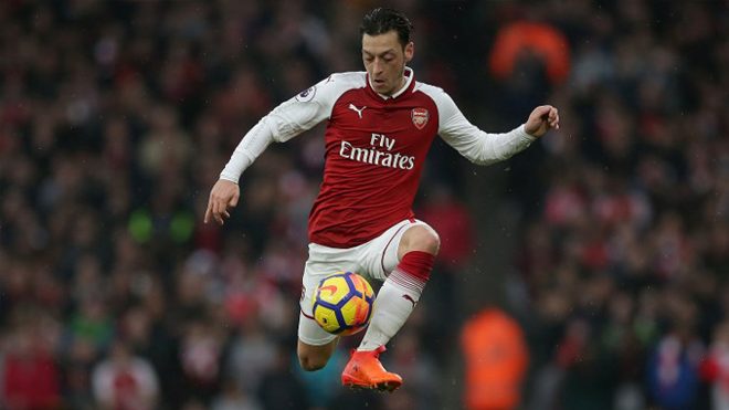In this file photo taken on November 18, 2017 Arsenal's German midfielder Mesut Ozil controls the ball during the English Premier League football match between Arsenal and Tottenham Hotspur at the Emirates Stadium in London. German playmaker Mesut Ozil ended speculation over his future at Arsenal by agreeing a new three-year deal with the Premier League giants on February 1, 2018. Daniel LEAL-OLIVAS / AFP