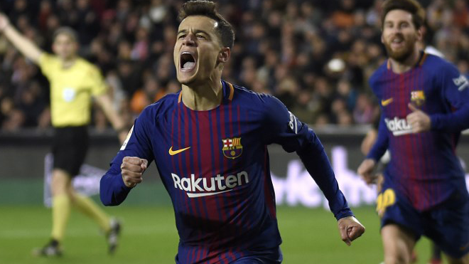 Barcelona's Brazilian midfielder Philippe Coutinho celebrates a goal as Barcelona's Argentinian forward Lionel Messi approaches during the Spanish 'Copa del Rey' (King's cup) second leg semi-final football match between Valencia CF and FC Barcelona at the Mestalla stadium in Valencia on February 8, 2018. JOSE JORDAN / AFP