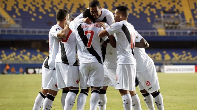 This picture released by Photosport shows Brazil's Vasco da Gama player Evander (top-C) celebrating his goal against Chile's Universidad de Concepcion during their Copa Libertadores 2018 football match at Ester Roa Rebolledo stadium in Concepcion, Chile, on January 31, 2018. Javier TORRES / Photosport Chile / AFP