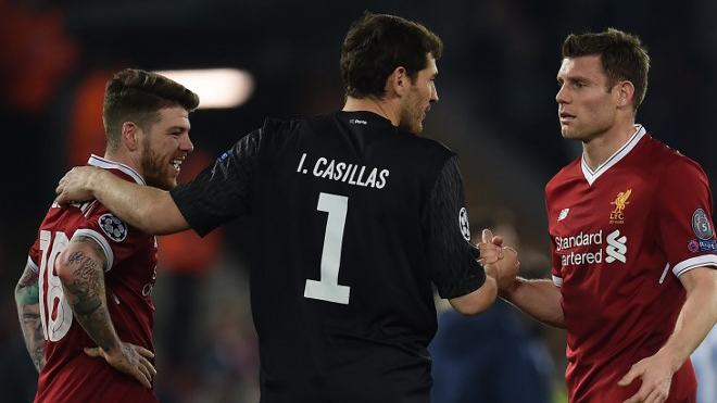 Porto's Spanish goalkeeper Iker Casillas (C) greets Liverpool's Spanish defender Alberto Moreno (L) and Liverpool's English midfielder James Milner after the UEFA Champions League round of sixteen second leg football match between Liverpool and FC Porto at Anfield in Liverpool, north-west England on March 6, 2018. PAUL ELLIS / AFP