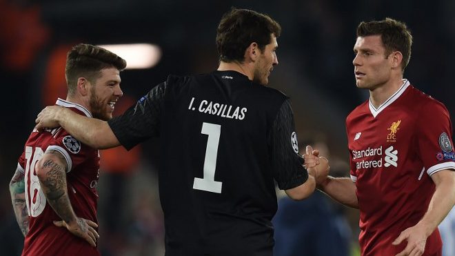 Porto's Spanish goalkeeper Iker Casillas (C) greets Liverpool's Spanish defender Alberto Moreno (L) and Liverpool's English midfielder James Milner after the UEFA Champions League round of sixteen second leg football match between Liverpool and FC Porto at Anfield in Liverpool, north-west England on March 6, 2018. PAUL ELLIS / AFP