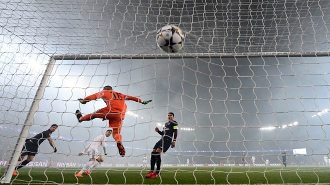 Real Madrid's Portuguese forward Cristiano Ronaldo heads the ball and scored a goal despite Paris Saint-Germain's French goalkeeper Alphonse Areola during the UEFA Champions League football match Paris Saint-Germain vs Real Madrid, on March 6, 2018 at the Parc des Princes stadium in Paris. FRANCK FIFE / AFP