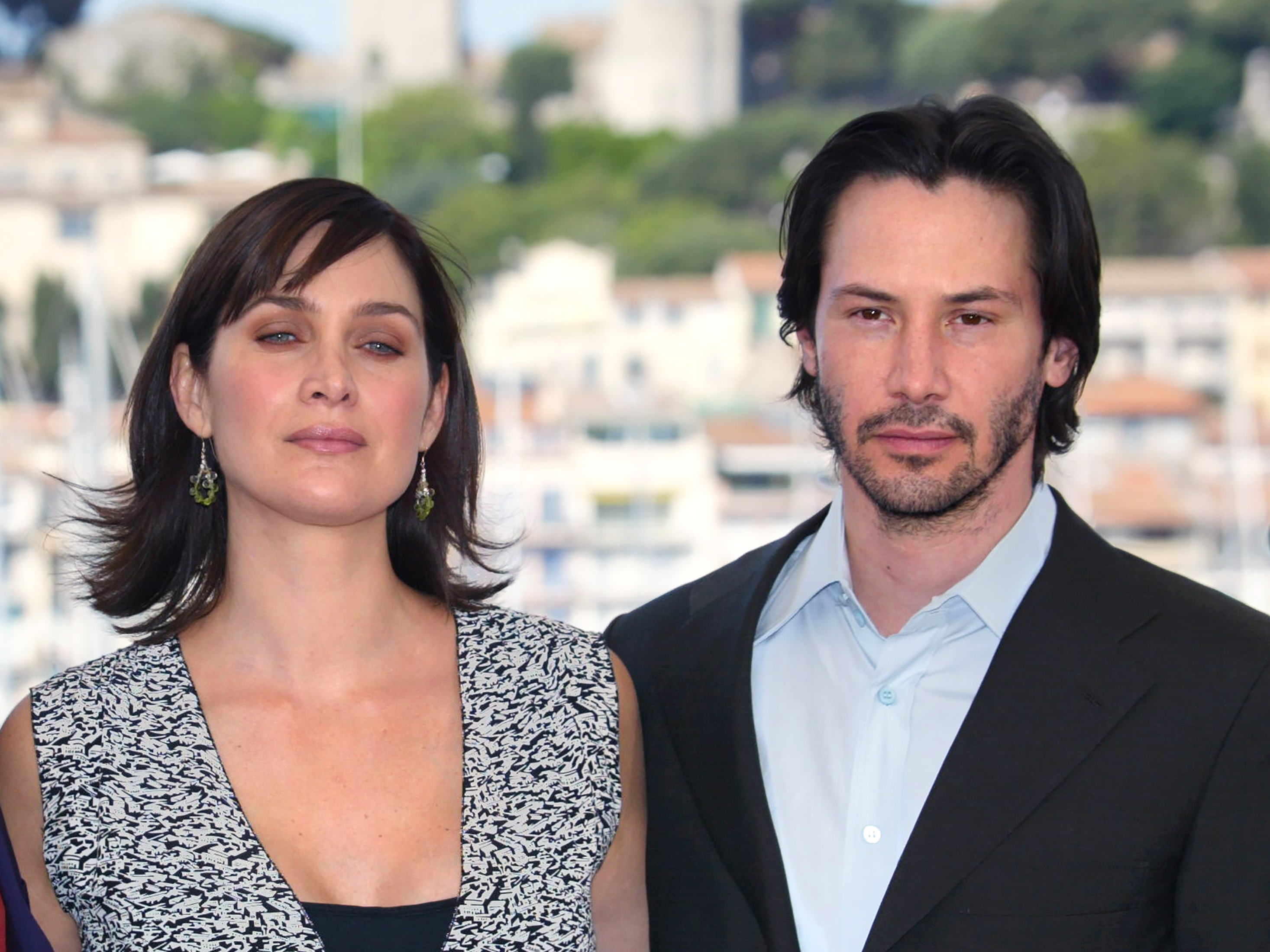 US actor Keanu Reeves and Canadian-born actress Carrie-Anne Moss pose for photographers on a terrace of the Palais des festivals during the photocall for "Matrix Reloaded" directed by the Wachowski brothers during the 56th Cannes film festival on 15 May 2003. - Sci-fi franchise "The Matrix" will return for a fourth film with Keanu Reeves reprising his role as kung fu-kicking, shades-wearing hero Neo, studio Warner Bros said Tuesday.
Lana Wachowski will helm the project, returning to write, direct and produce the latest installment of the hugely popular series about humans trapped in a virtual reality by machines, which has netted more than $1.6 billion worldwide. (Photo by FRANCOIS GUILLOT / AFP) / ALTERNATIVE CROP        (Photo credit should read FRANCOIS GUILLOT/AFP/Getty Images)