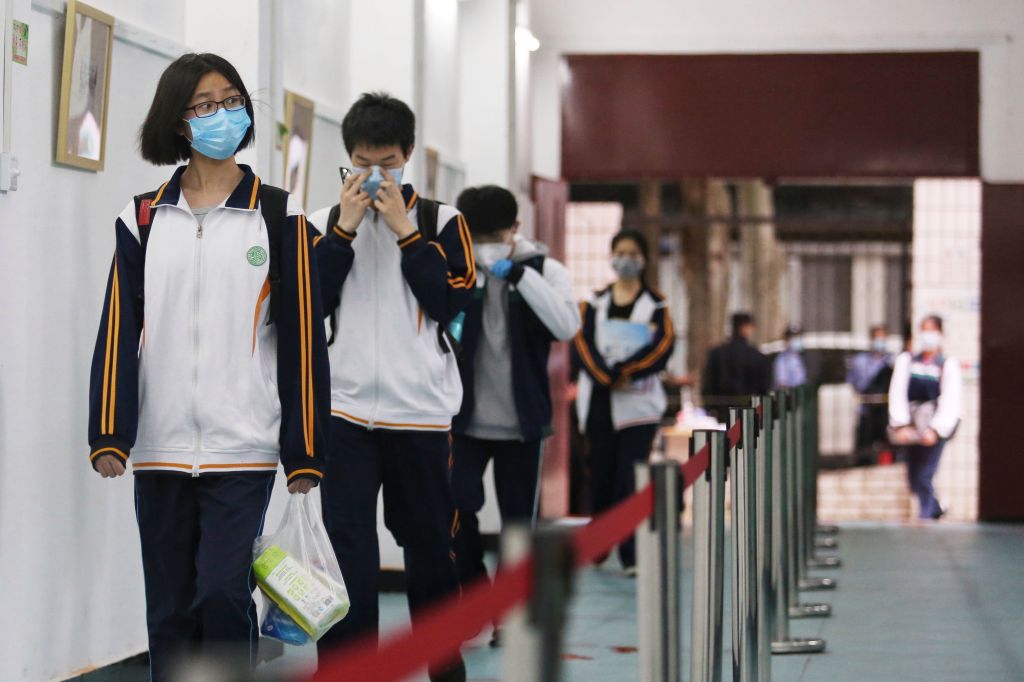 Senior students enter a high school in Wuhan in China's central Hubei province on May 6, 2020. - Senior school students returned to class on May 6 in the central Chinese city of Wuhan, where the coronavirus that has now swept the globe first emerged late last year. (Photo by STR / AFP) / China OUT